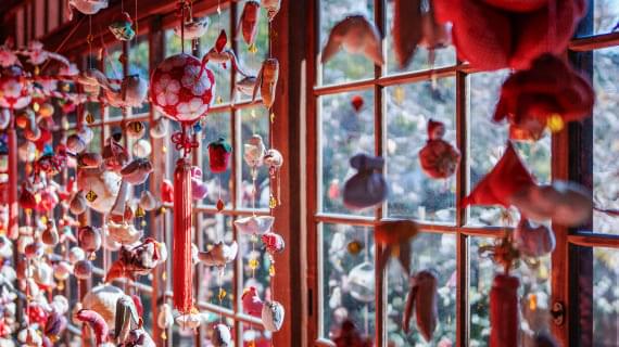 Traditional red decorations hang from window frames, creating a decorative atmosphere.